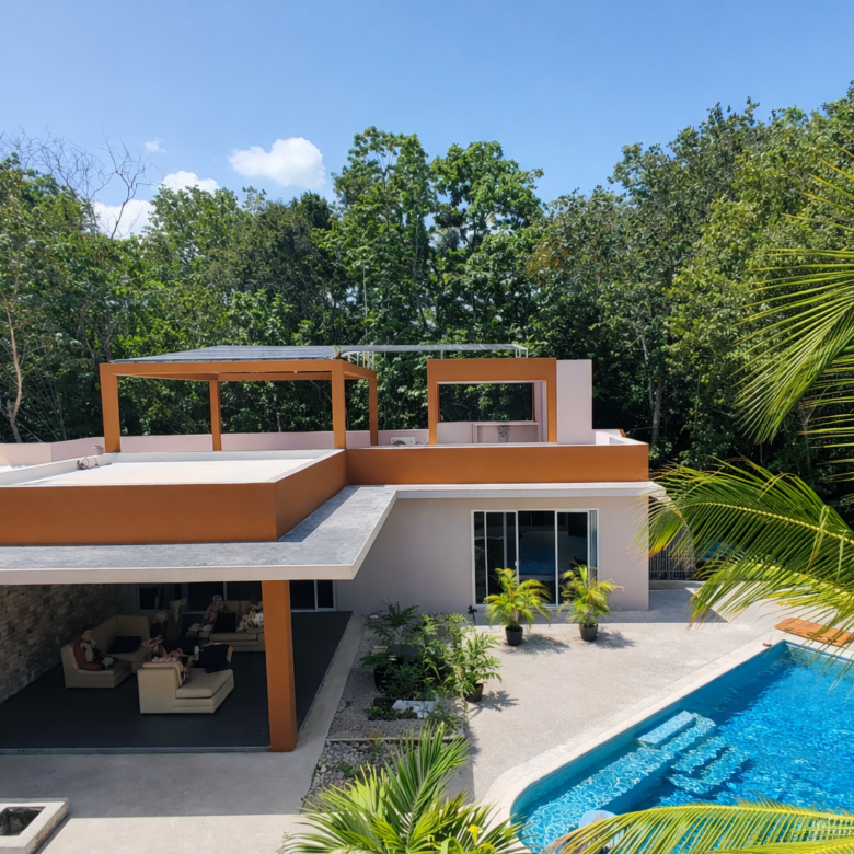 Hacienda Richardson for sale in Los Árboles Tulum, listed by Play-Investments.com. Sustainable mid-century home on 5 acres with solar system, guest house and potable water. USD 420,000.